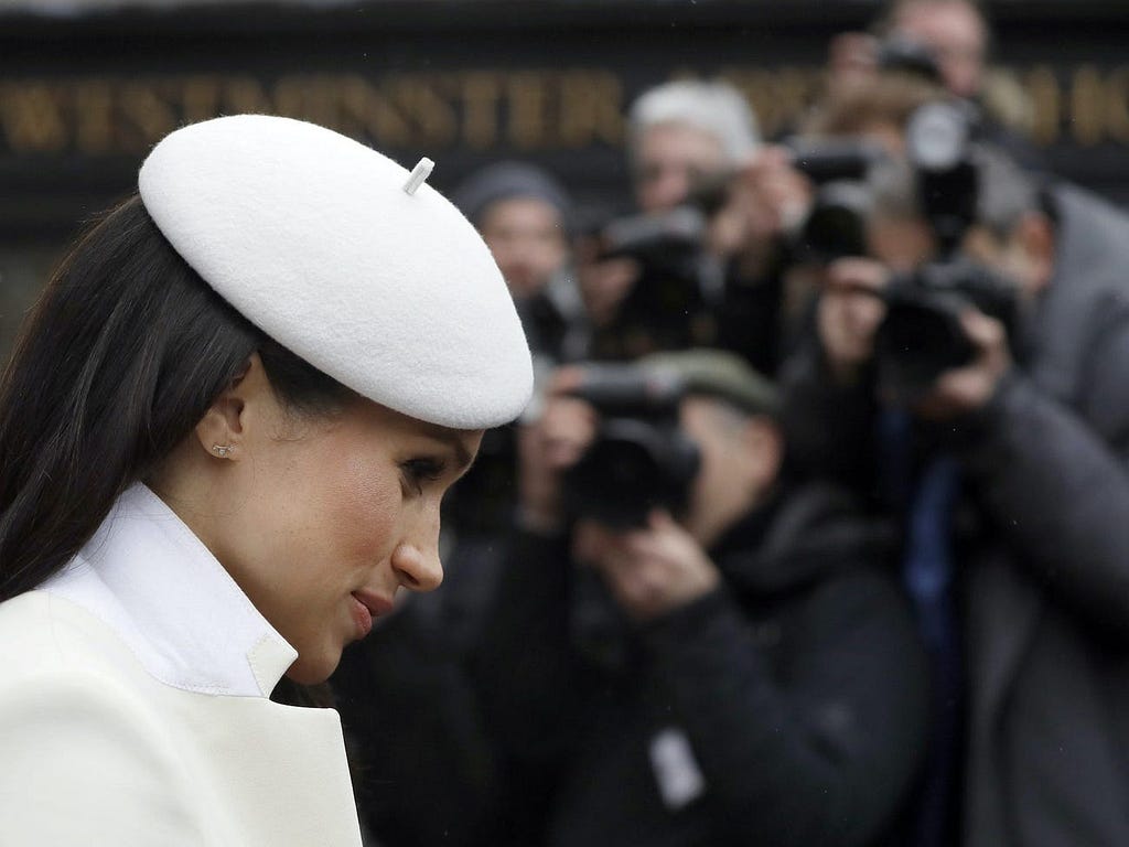 Photographers focus on Meghan Markle during an event in London in March 2018.