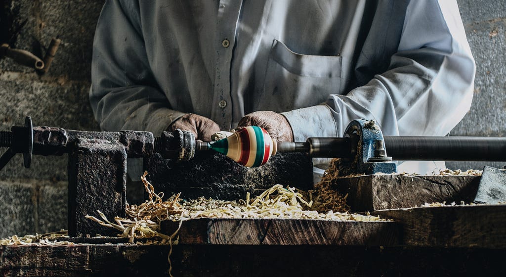 Artisan making a spinning top