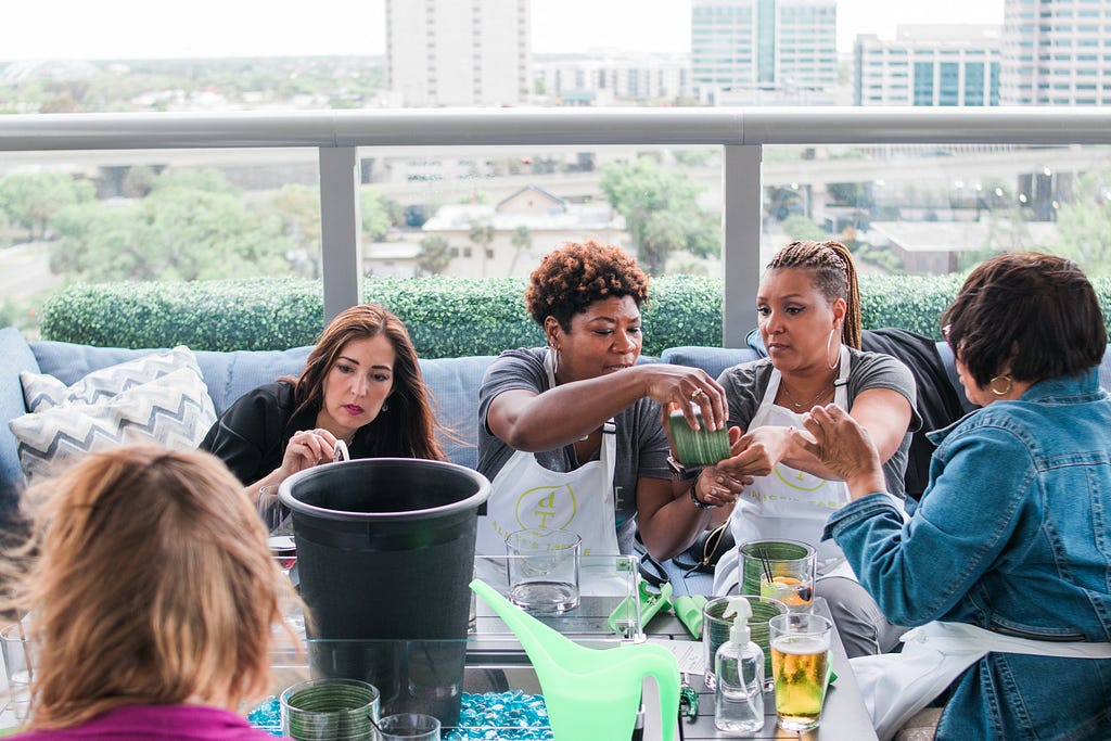 women making flower arrangements during Alice's Table workshop in Jacksonville, Florida