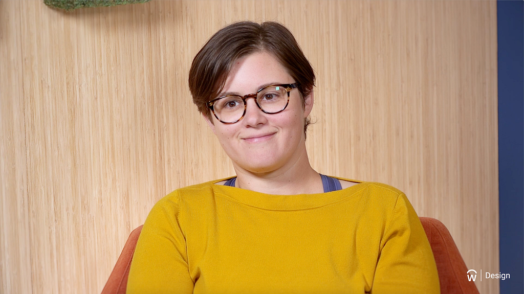 Video still of a woman, Beth Budwig, with glasses.