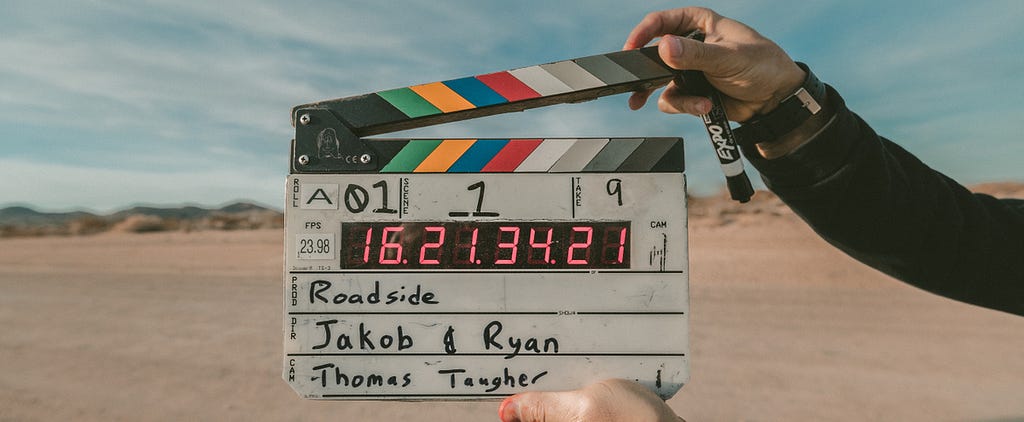 Person holding clapperboard.