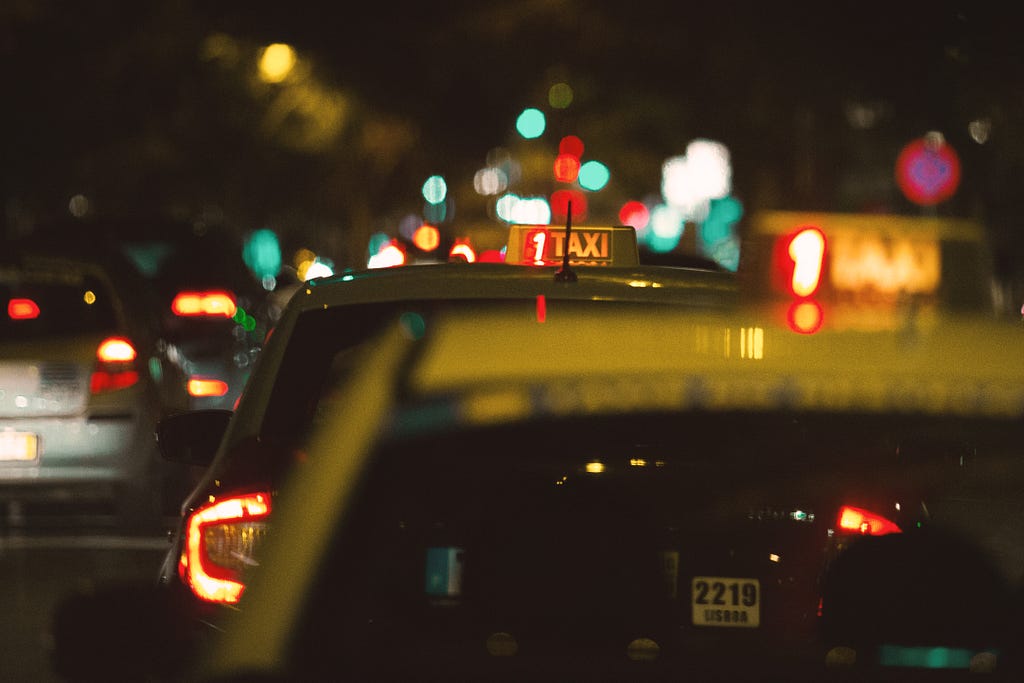 A blurry photo of taxis at night