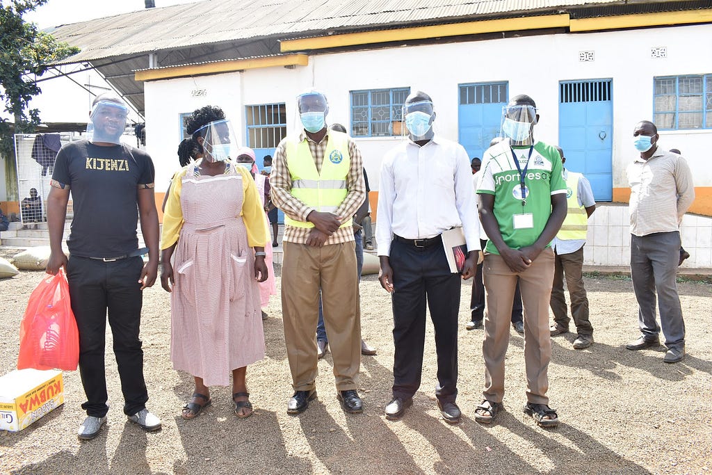 David Oginga, celebrates a large delivery of face shields and other PPE for the workers at Kisumu’s largest outdoor market.