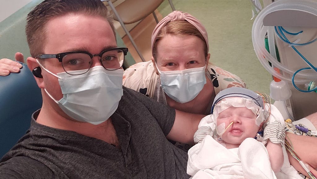 Michael and Amber with baby Rowan, their child diagnosed with a rare genetic seizure disorder