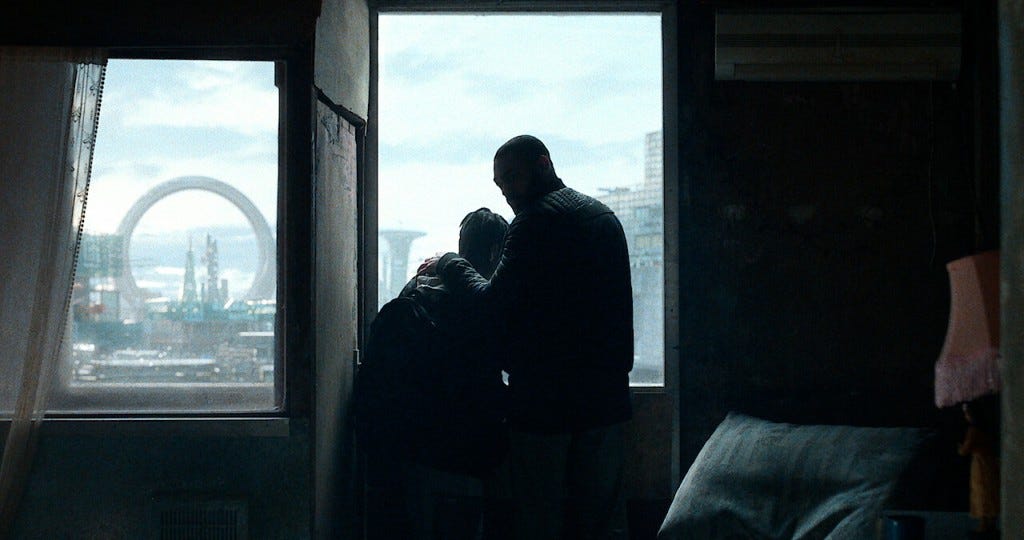 A warm embrace of man and a boy against a skyline view window