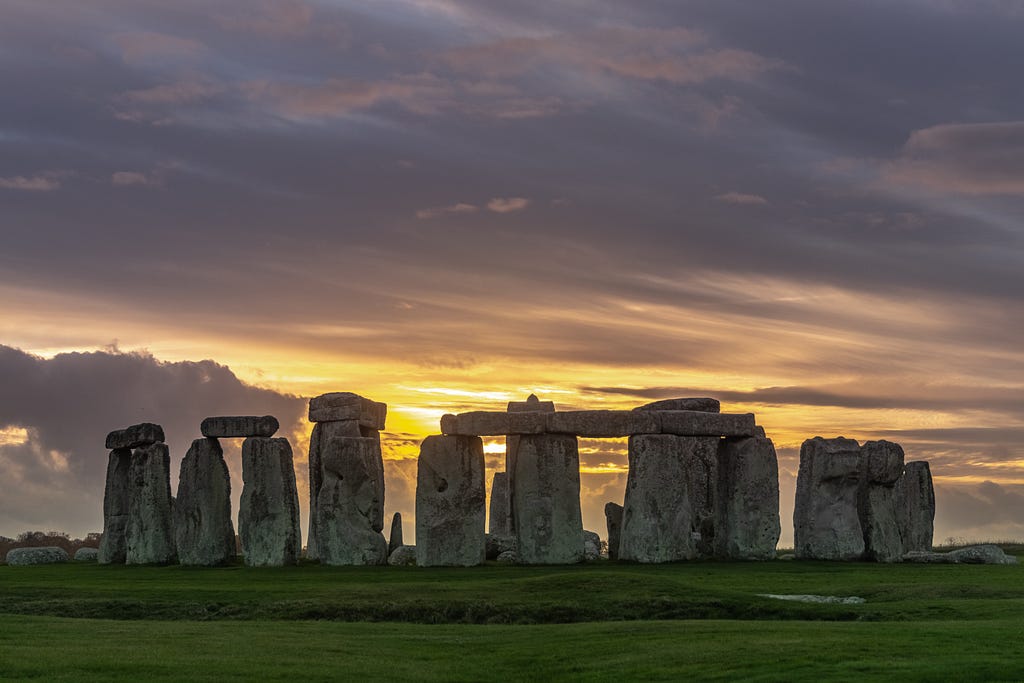 A beautiful picture of Stonehenge with a lavender gray sky.