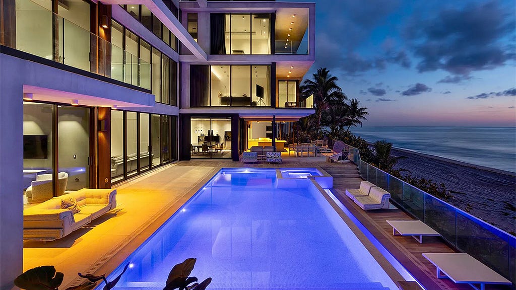 A modern glass house on the beach