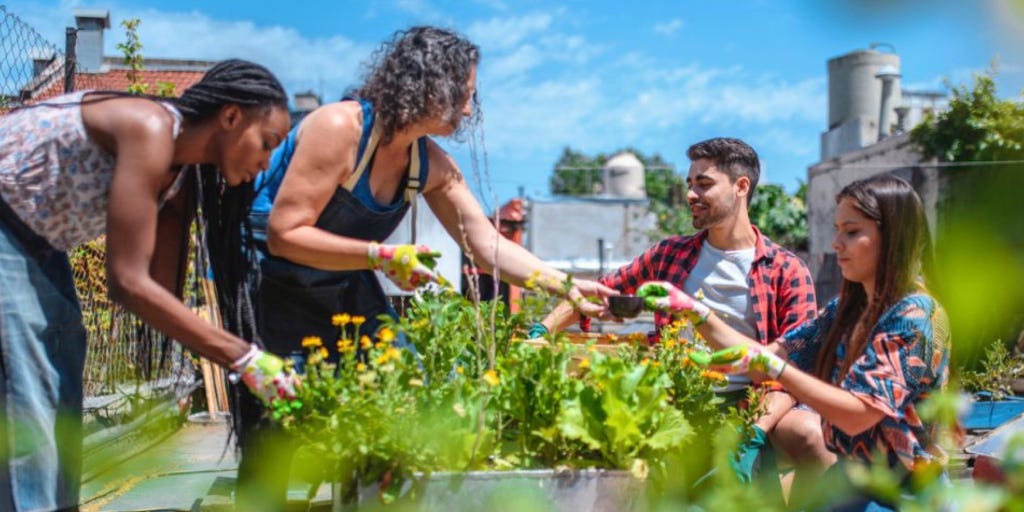 group of people coming together over planting