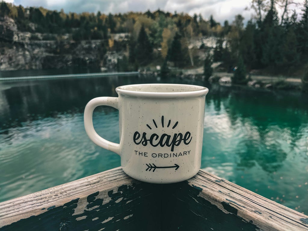 Mug that says “Escape the ordinary” on it