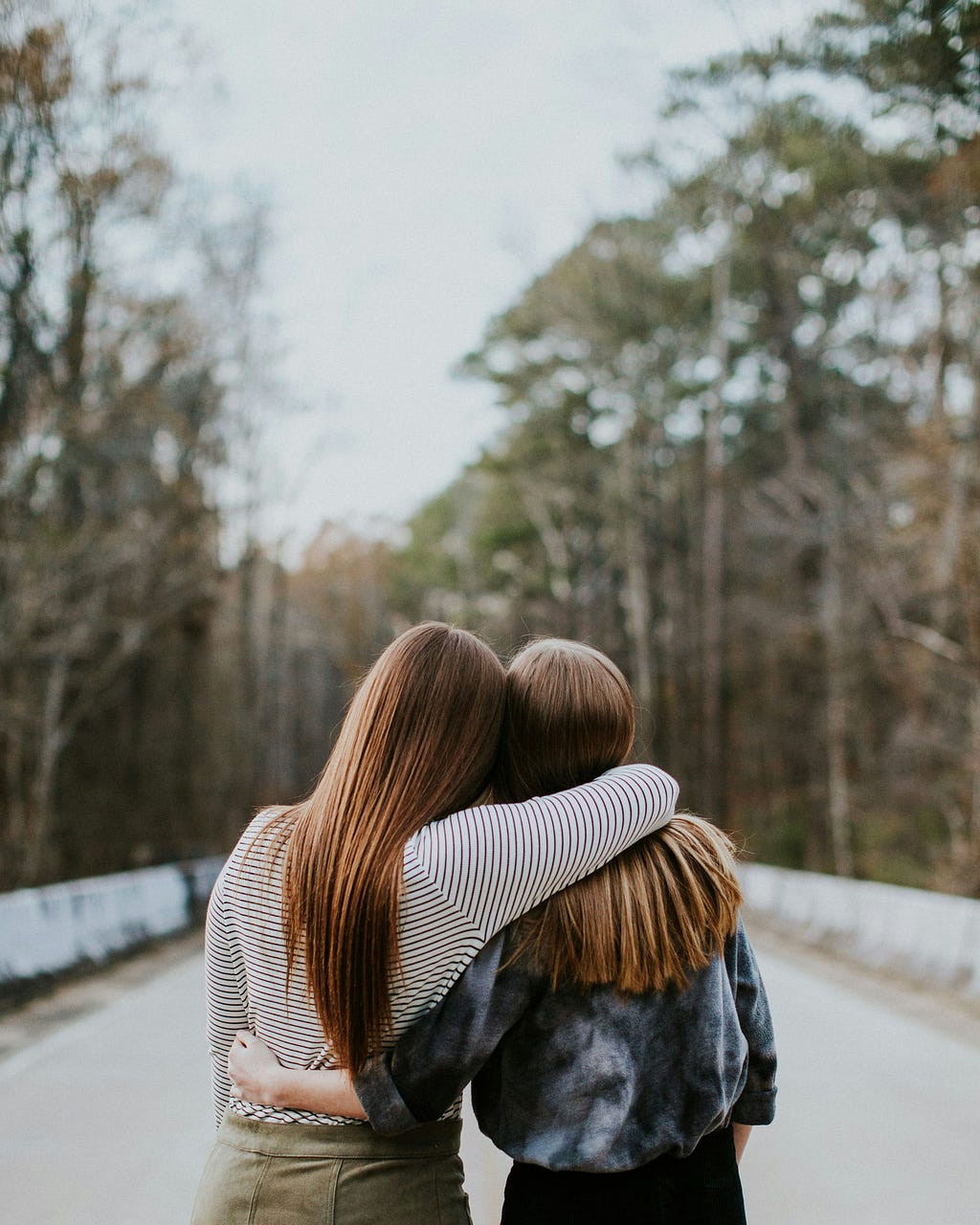 Two female friends, one with her arm around the other