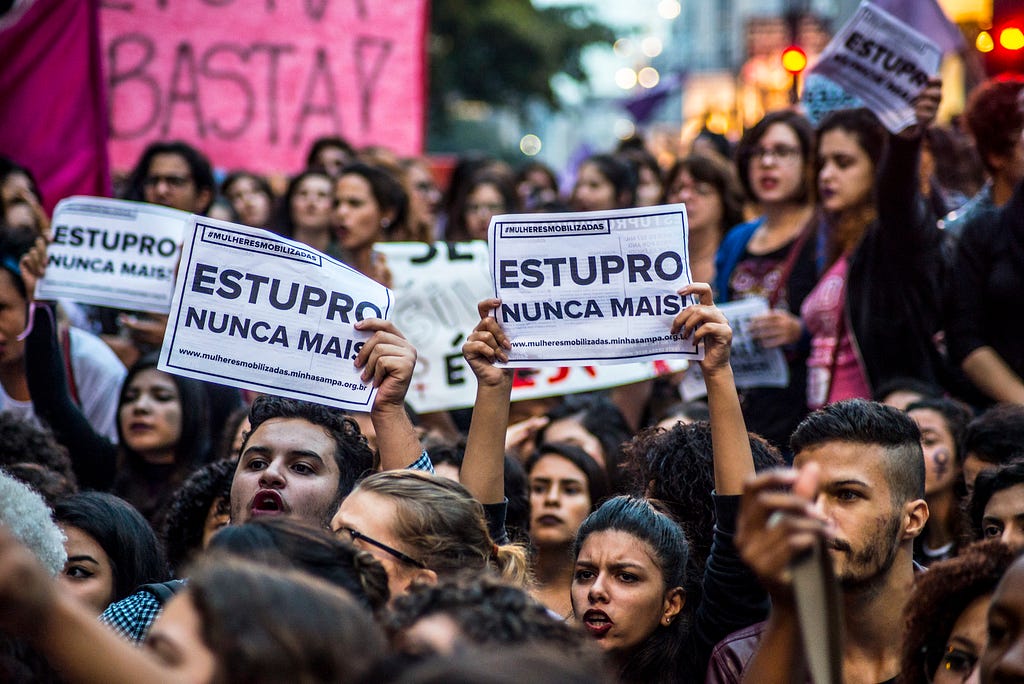 SAO PAULO, BRAZIL - JUN 01:  People display banners during a protest against the gang-rape of a 16-year-old girl last week in a favela in Rio de Janeiro on June 01, 2016 in Sao Paulo, Brazil. Police arrested two men on May 30 and hunted four others in the alleged gang rape of an unconscious teenage girl that came to light through an online video that shocked Brazil. Social networks erupted with outrage over the video posted on May 21 featuring the girl naked on a bed and the apparent rapists bragging that she had been raped by more than 30 men. (Photo by Cris Faga/LatinContent/Getty Images)