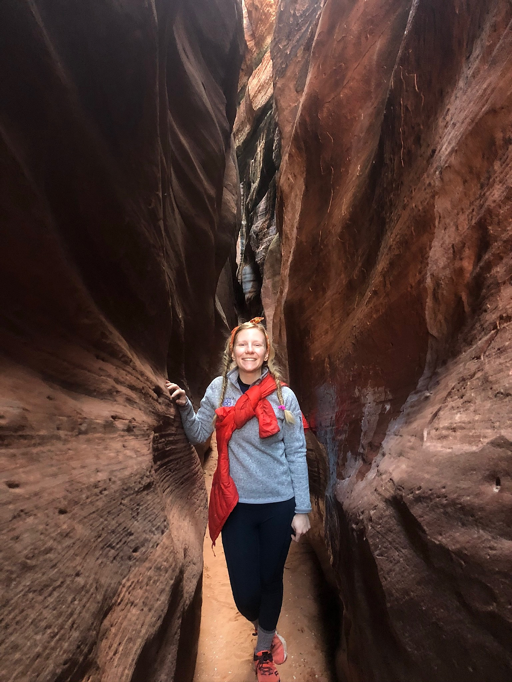Laura stands in a slot canyon in Arizona, one week before quarantine!