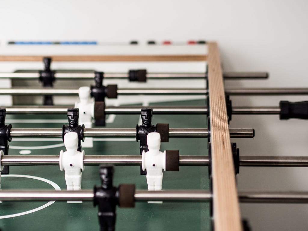 A picture of a soccer table game.