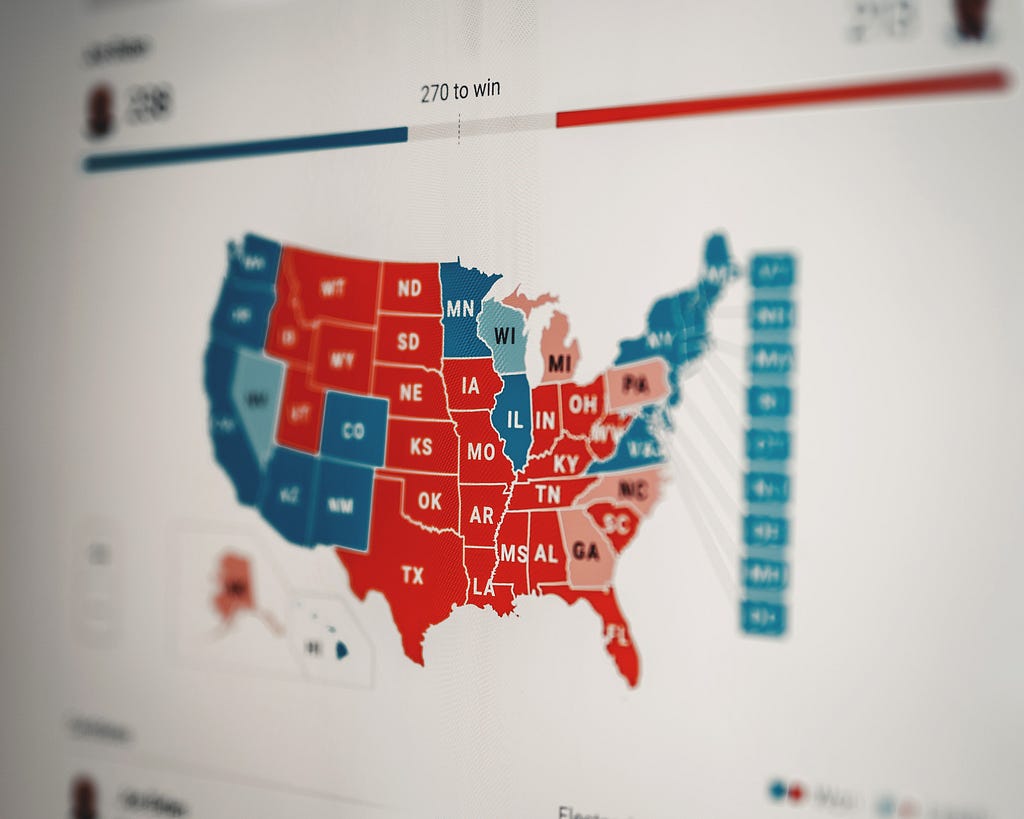 Map of the US with red states and blue states colored and evolving election results for some states noted.