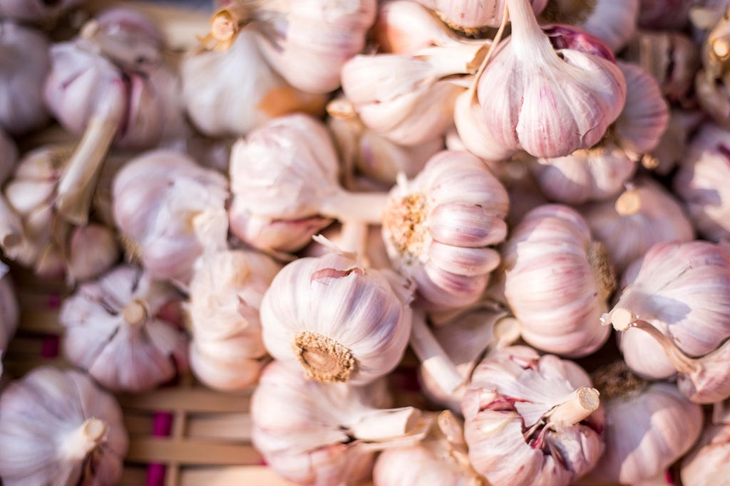 A collection of garlic bulbs in a basket