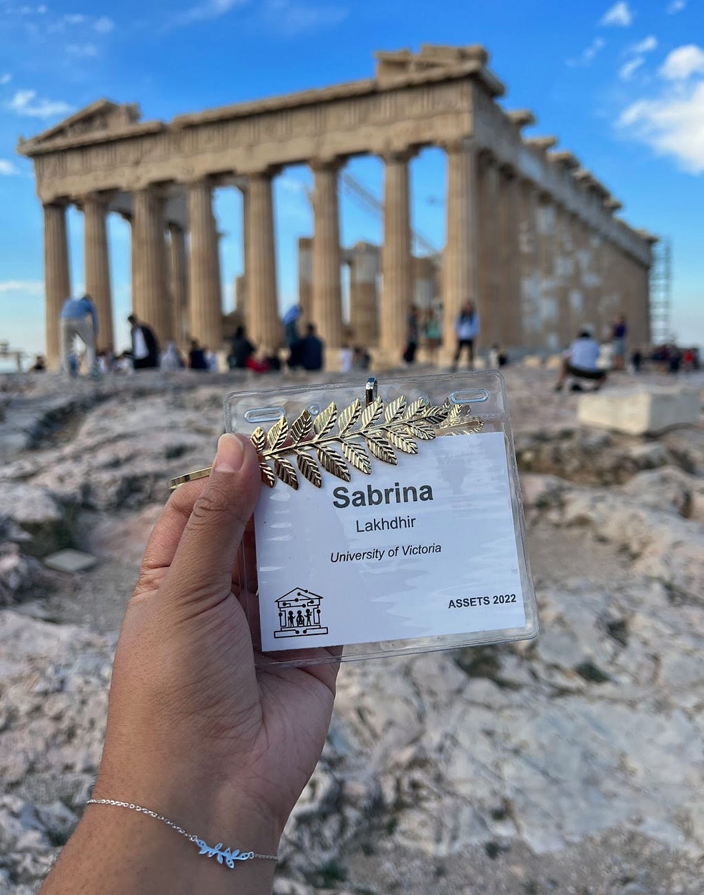 An image of the author’s nametag from the conference stating their name, their affiliation (University of Victoria) and the conference name and logo in front of the Parthenon.