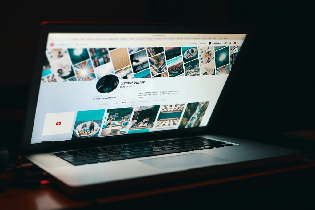 A laptop showing a Pinterest profile