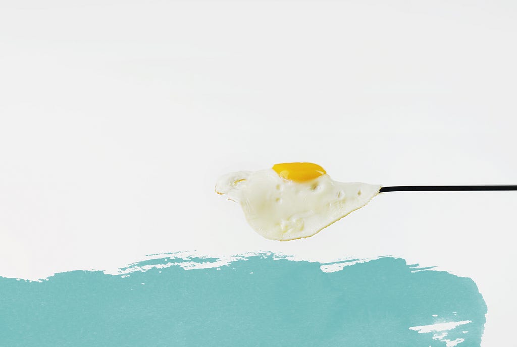 A fried egg on a white and blue background
