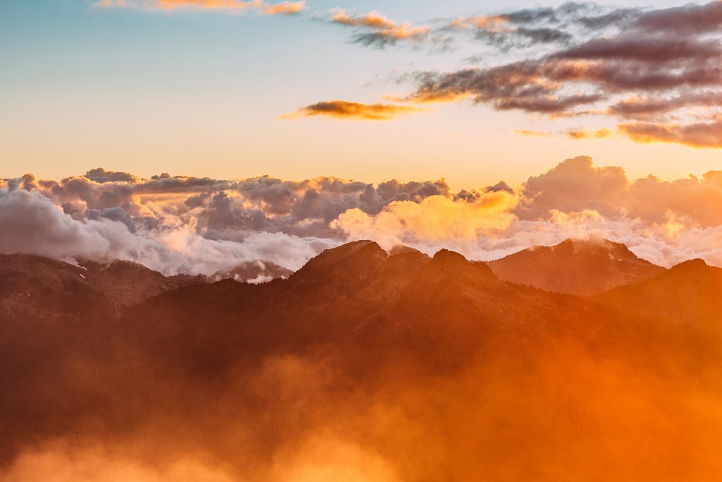 a scenic skyline of a mountain and clouds.