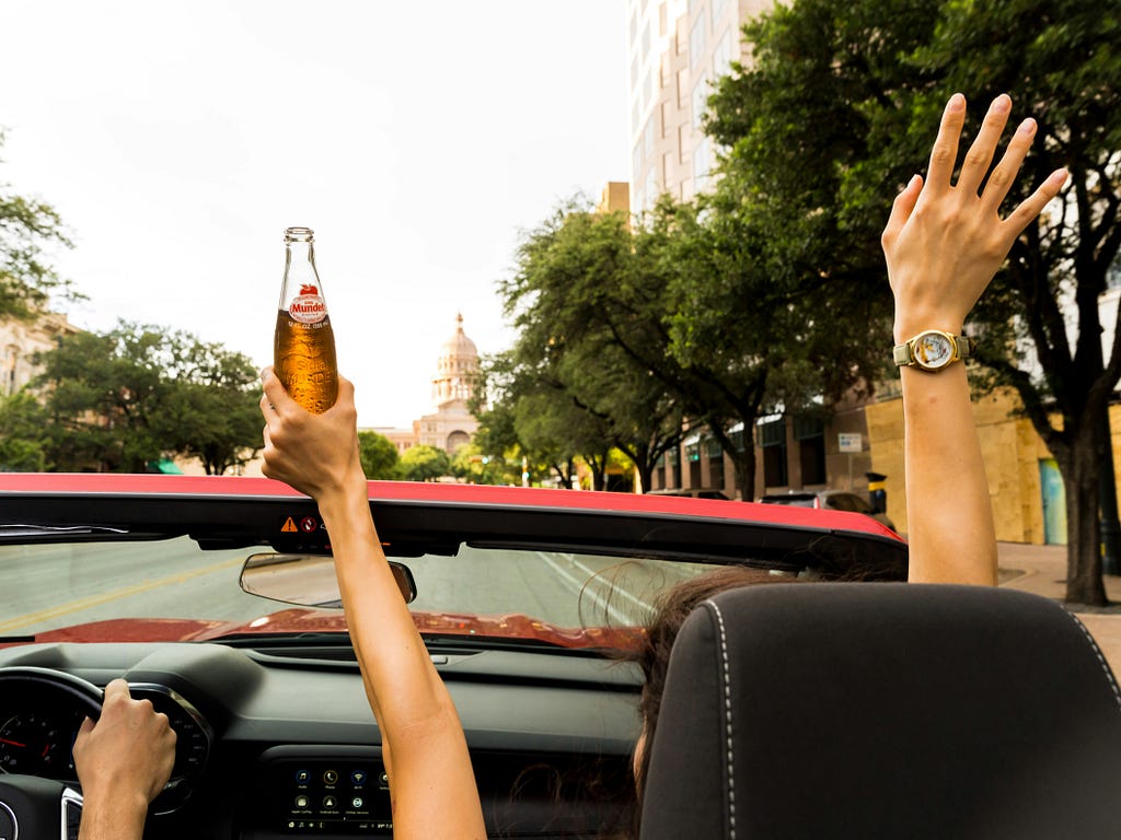 Couple riding in a convertible.