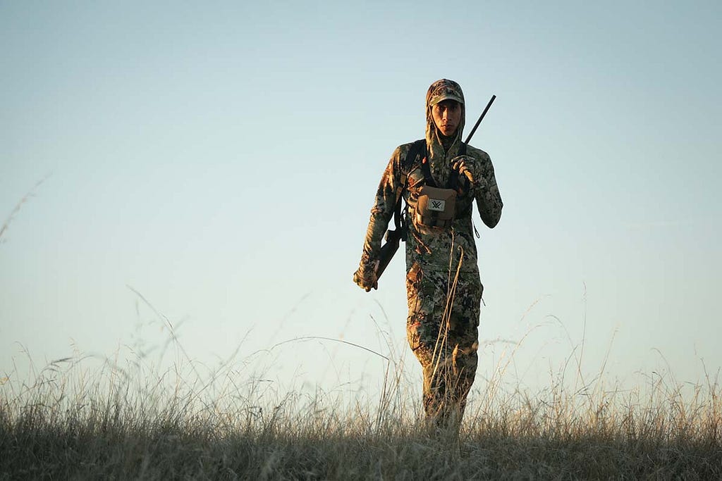 After a failed stalk, a hunter hikes back to his friends.