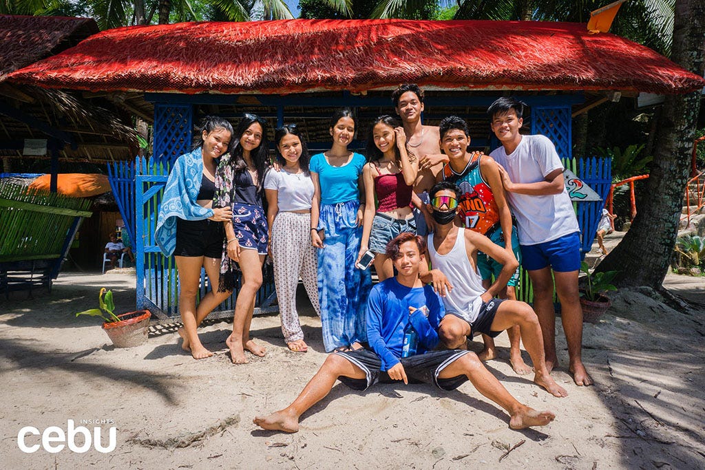 A bunch of Cebuanos posing for a picture at the beach