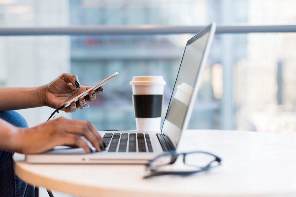 A person typing on their laptop