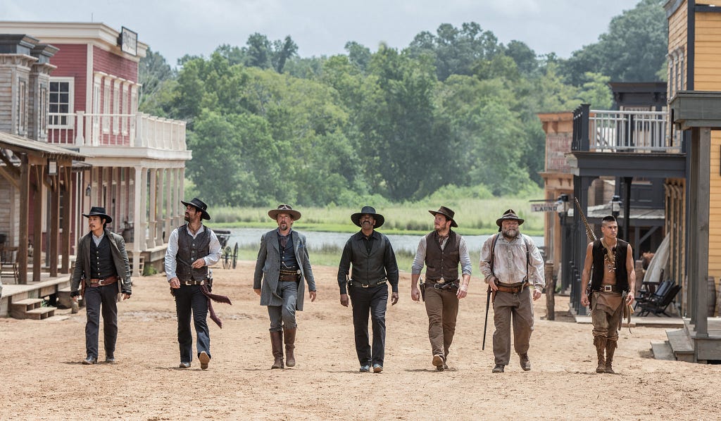 Heroes from Magnificent Seven movie from 2016 walking in Town Square