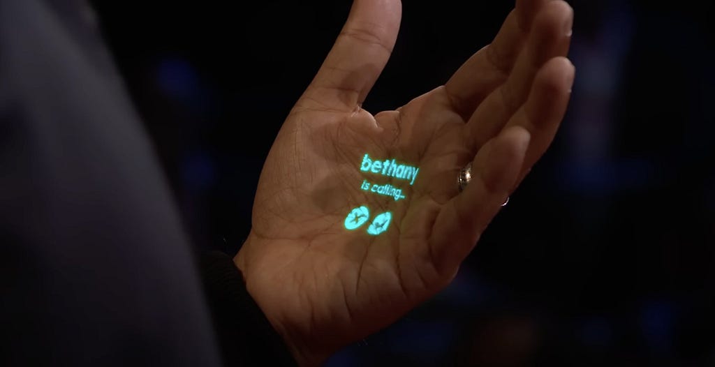 Imran Chaudhri demos the Humane AI Pin, “bethany is calling” is projected onto his hand with decline and accept buttons.