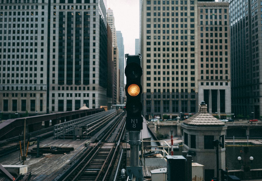 red light on a train track in a city