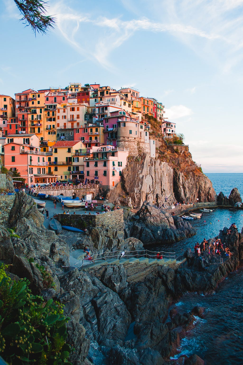 Colourful houses on cliffs with tourists in streets