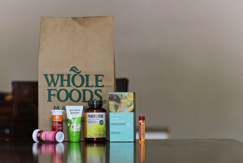 Whole Foods bag sits behind supplements