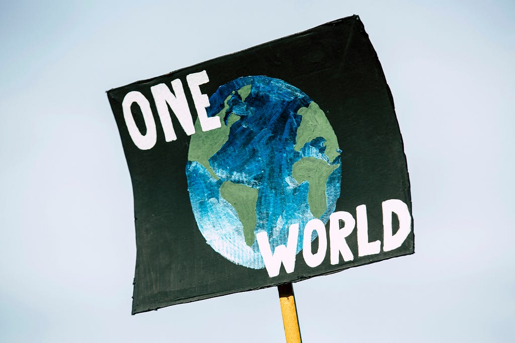 A banner that says ‘ONE WORLD.’