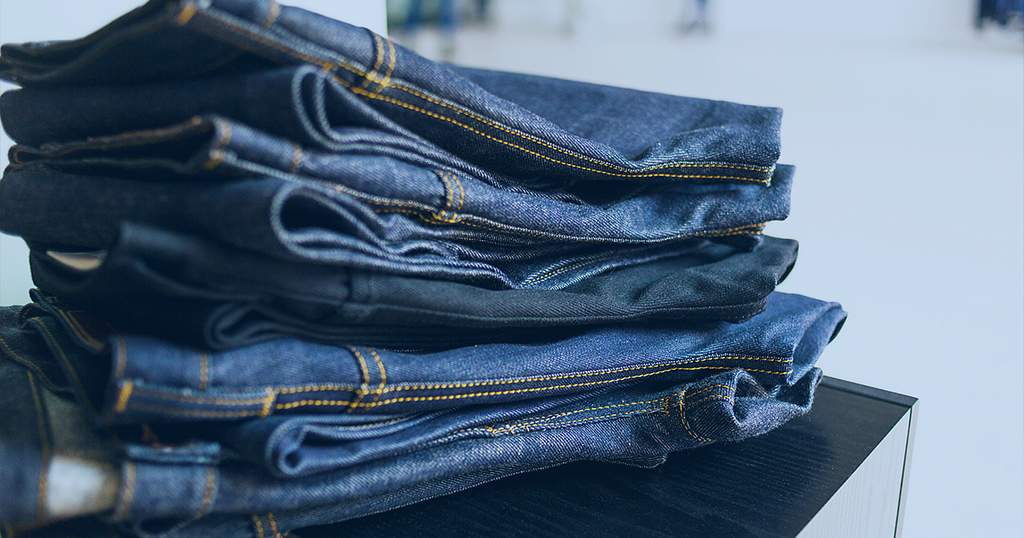 A picture showing a pile of new blue Jeans