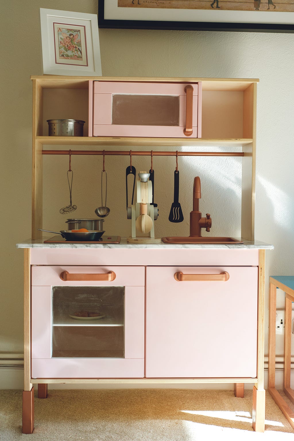 A pink child’s play kitchen