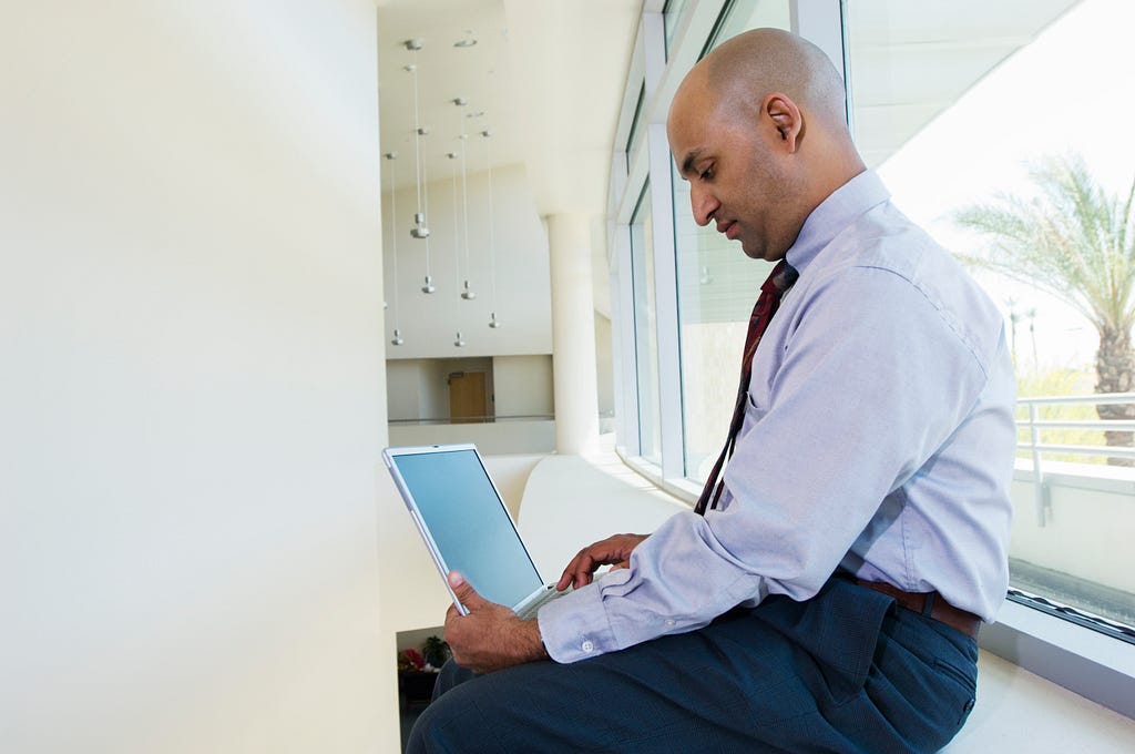 Indian businessman typing on his laptop.