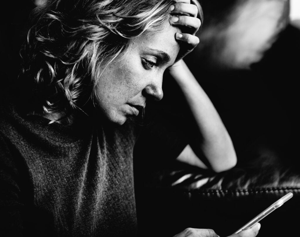 white-woman-using-mobile-phone — RumboMag — Tips for Overcoming Anxiety