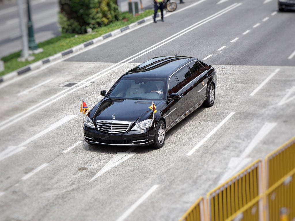 A picture of a diplomatic vehicle driving down the road.