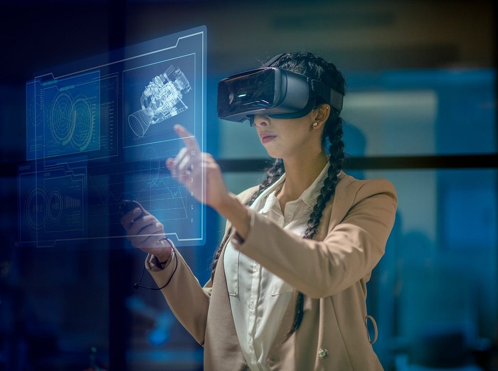 Woman using an augmented reality headset looking at a virtual display. Photo by Fat Camera/Getty Images