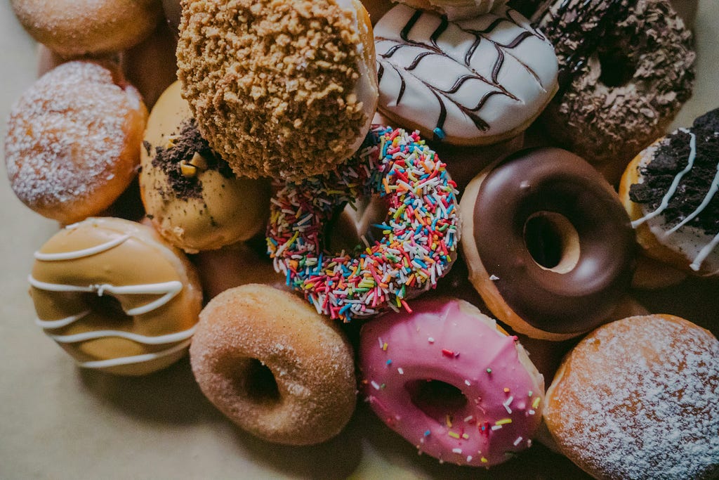 Close up of assortment of colorfully designed donuts