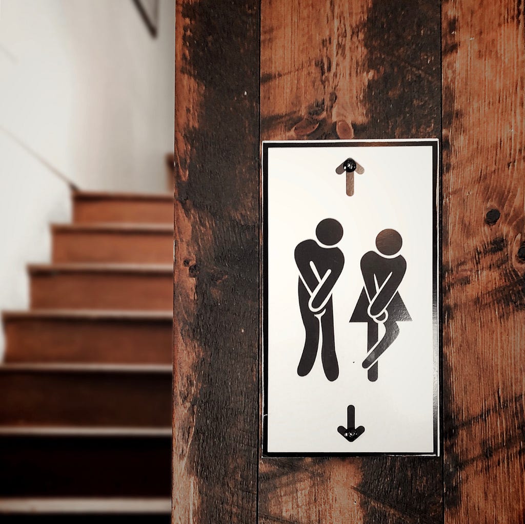Male and female illustrations, indicating they need to use the bathroom