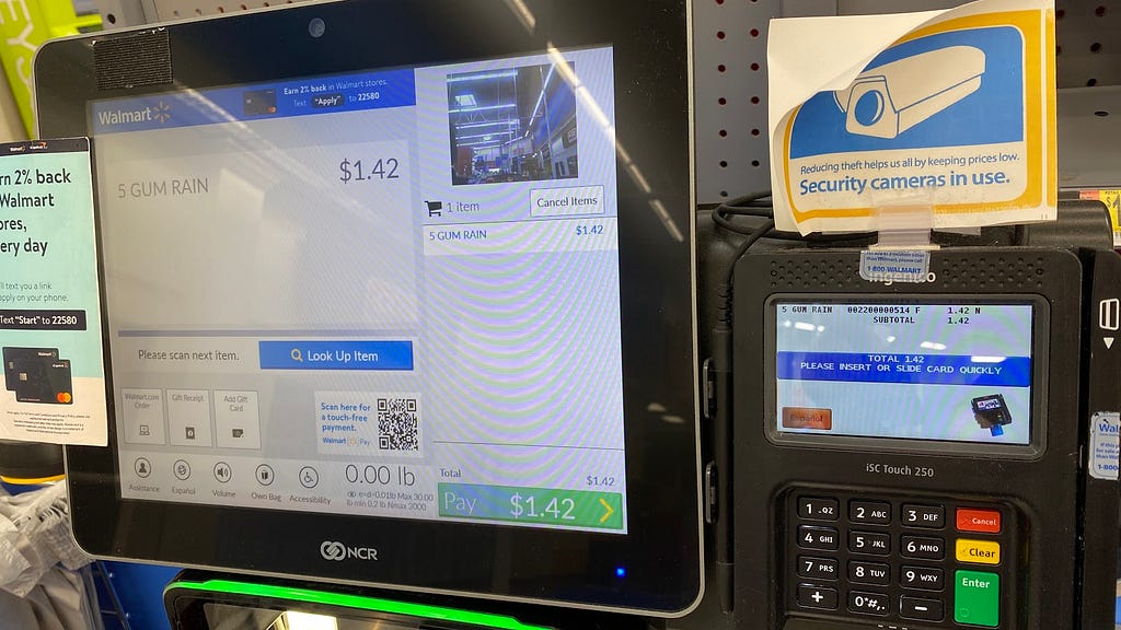 Self checkout machine from Walmart that shows the price per item scanned and the total price to be paid.