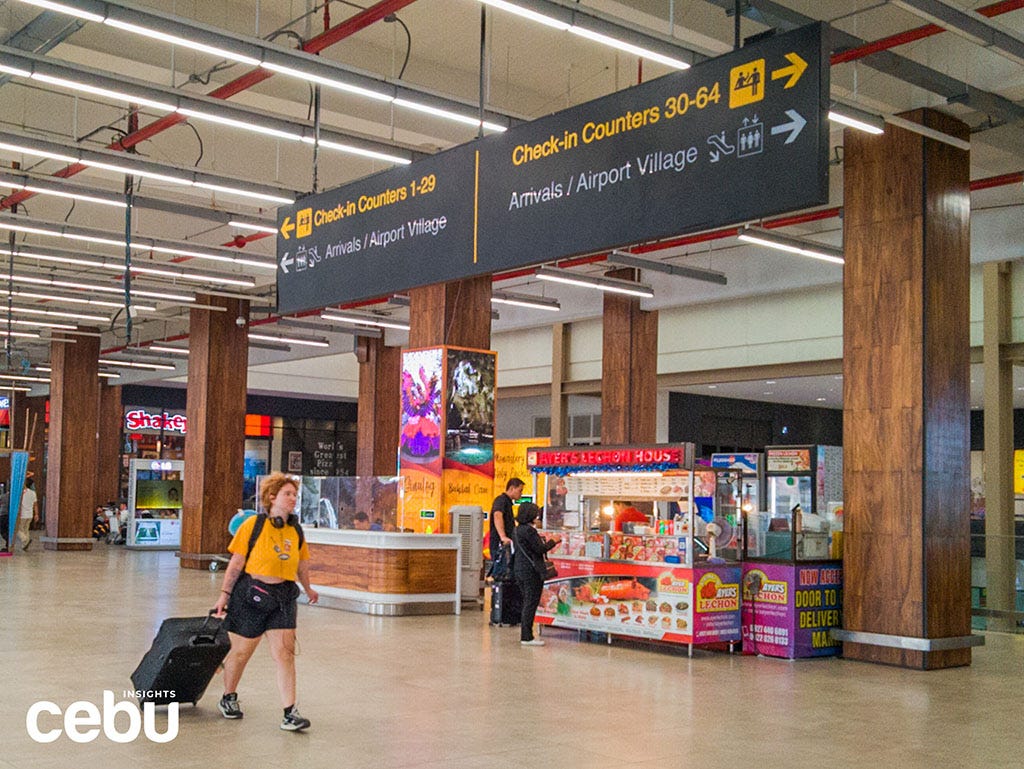 Tourists walks through Terminal 1 of the MCIA