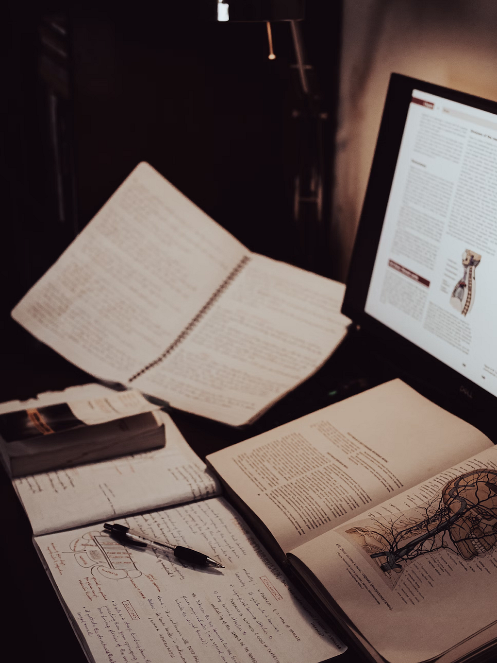 a well-lit desk with an open book resting on its surface