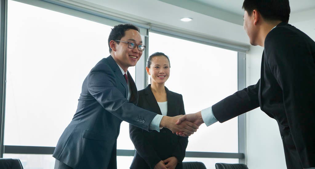 Entrepreneur successfully shaking hand with investors