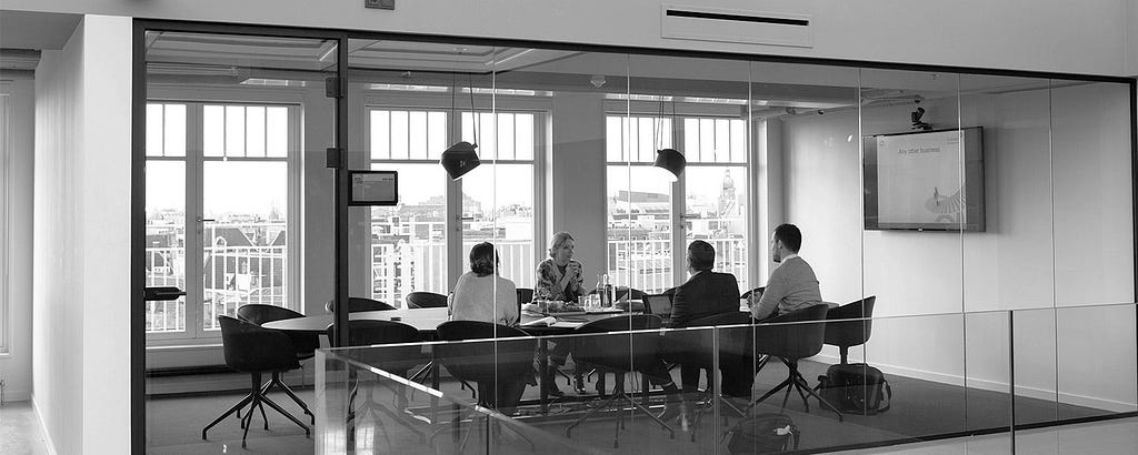 Group of people at a table in a conference room