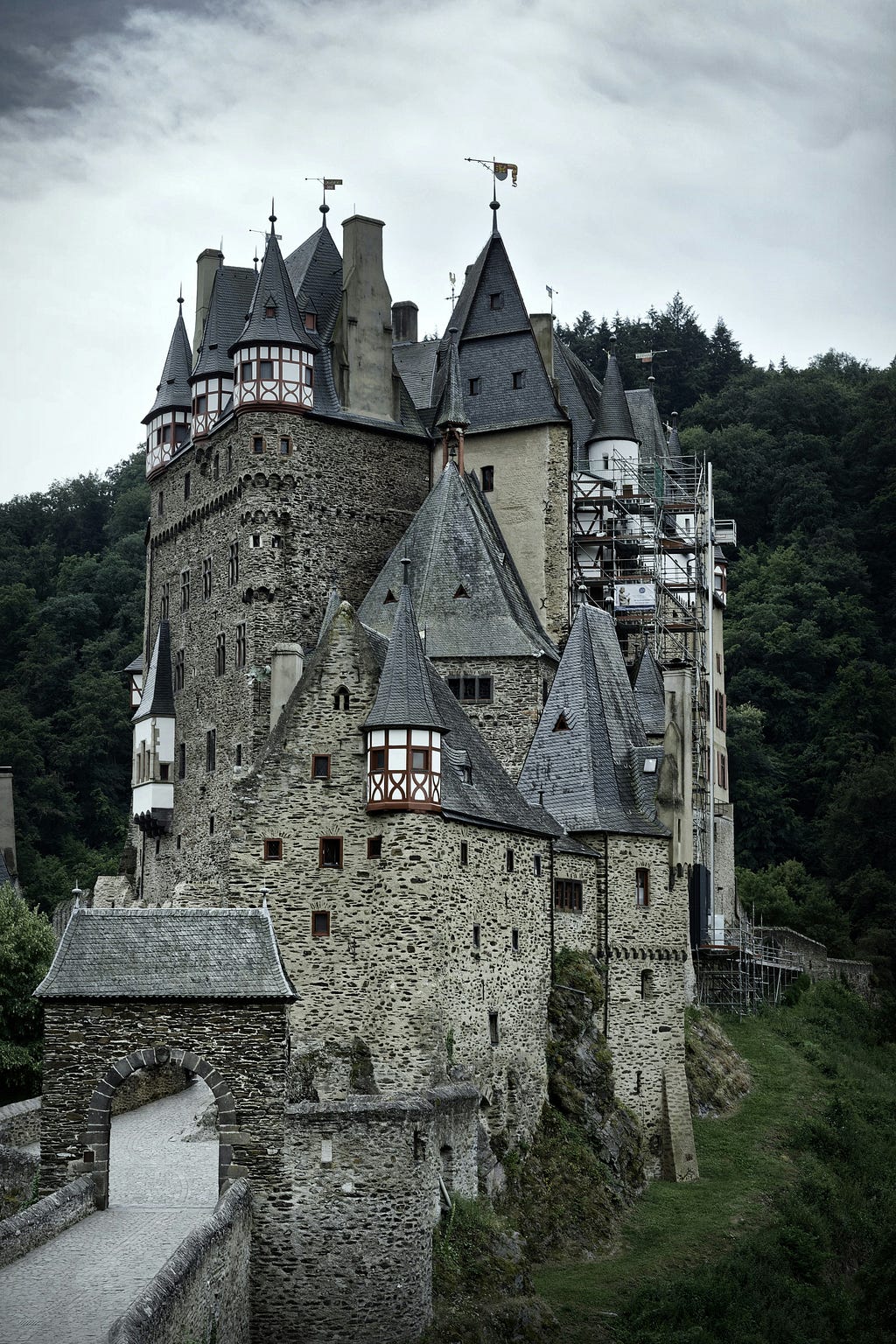 Large multitowered castle on a mountain side.