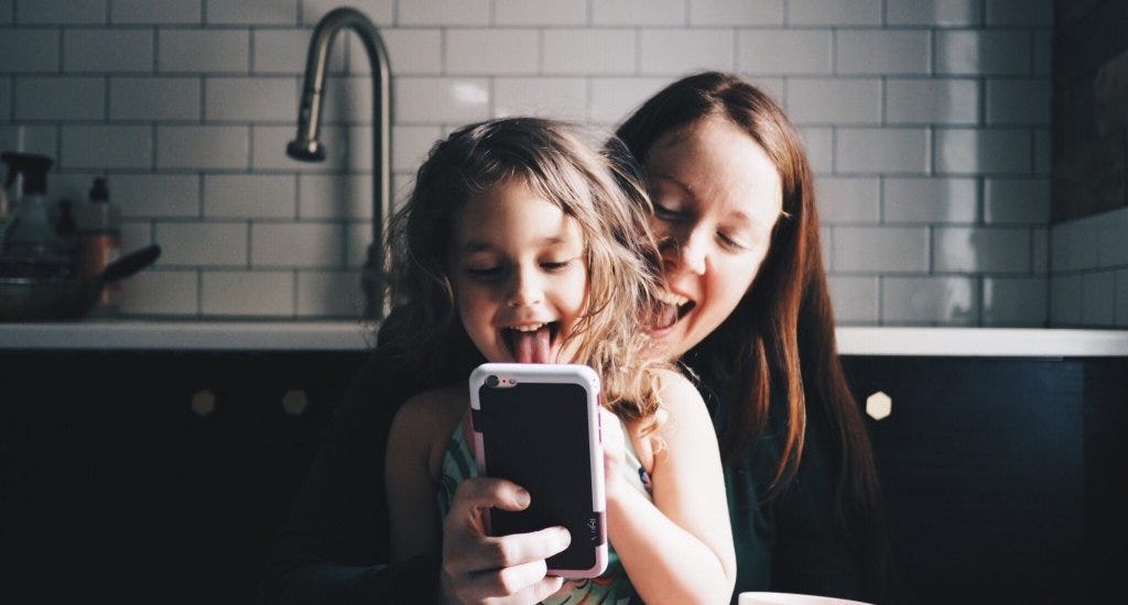 An entrepreneur and her daughter taking a selfie