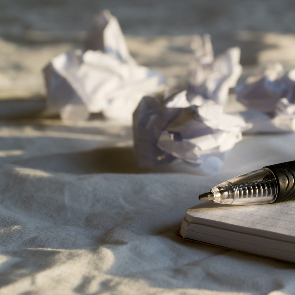 Crumpled paper and a pen