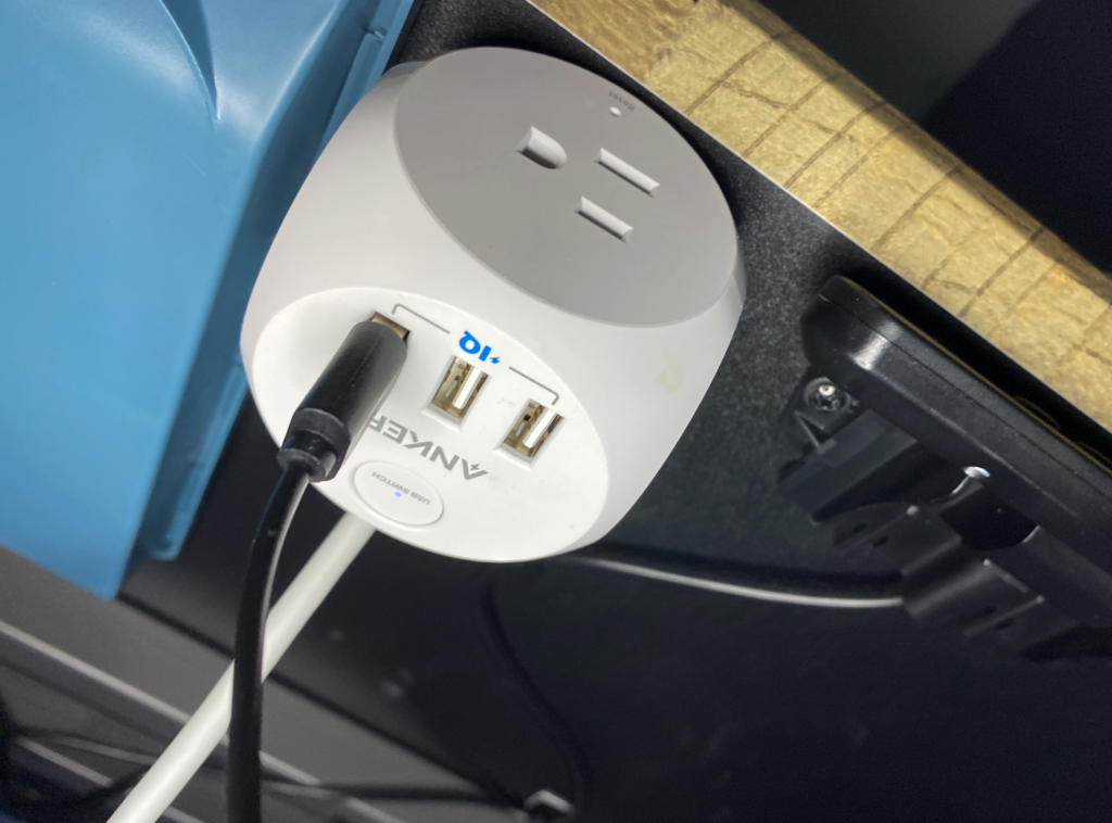 remote work from home office desk essential Anker Power Cube that I use under my home office standing desk, attached with a command strip so that I have quick access to more outlets in my office.